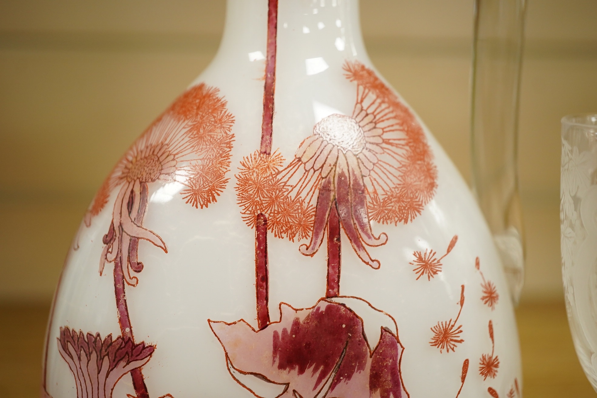 A Continental Art Nouveau glass carafe enamelled with flowers, an English wine glass engraved with the symbols of the Union, a Victorian engraved claret jug and a toddy lifter. Condition - carafe has some occasional scra